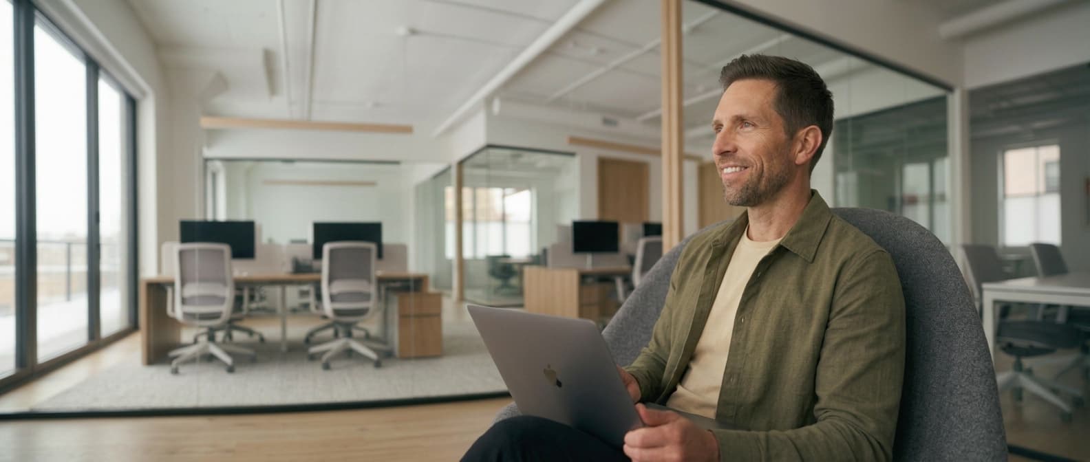 Man with laptop in a modern office